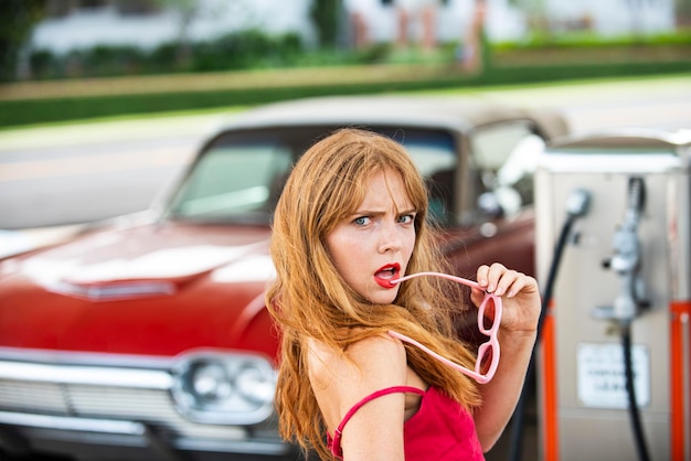 Premium Photo Sexy Woman At Gas Station Elegant Lady Against Red