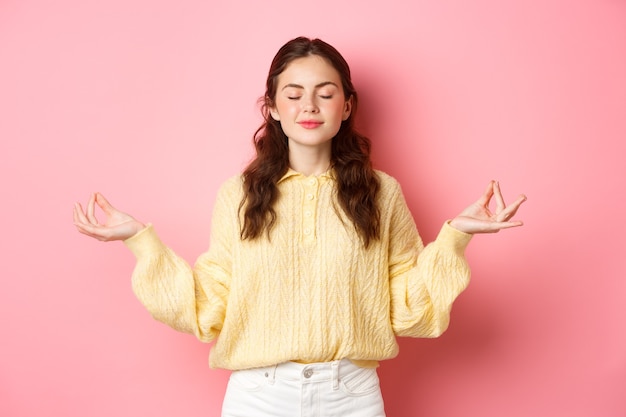 Premium Photo | She is relaxed. smiling young peaceful girl meditating ...