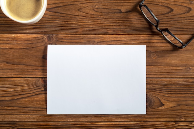 Premium Photo | A sheet of paper on a wooden table