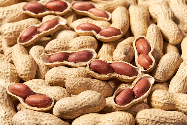 Premium Photo | Shelled and unshelled peanut background close-up ...