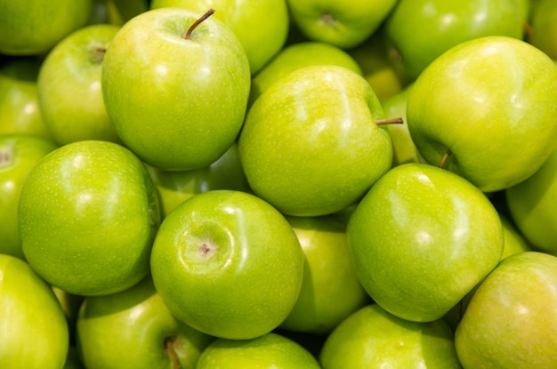 Premium Photo | Shiny green apple close-up pile for , healthy snack ...