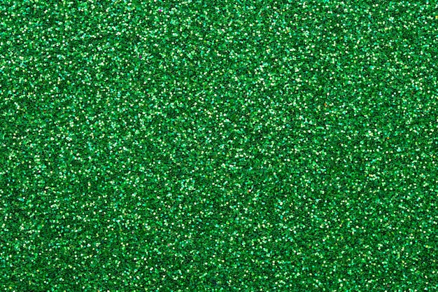 光沢のあるスパンコール生地 きらめく緑のテクスチャ 暗いキラキラの背景 テキスタイルのきらめく表面 プレミアム写真