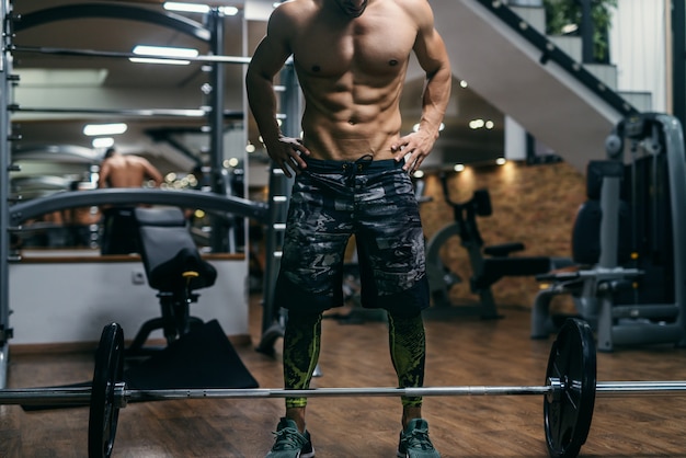 Premium Photo Shirtless Bodybuilder Preparing To Lift Barbells