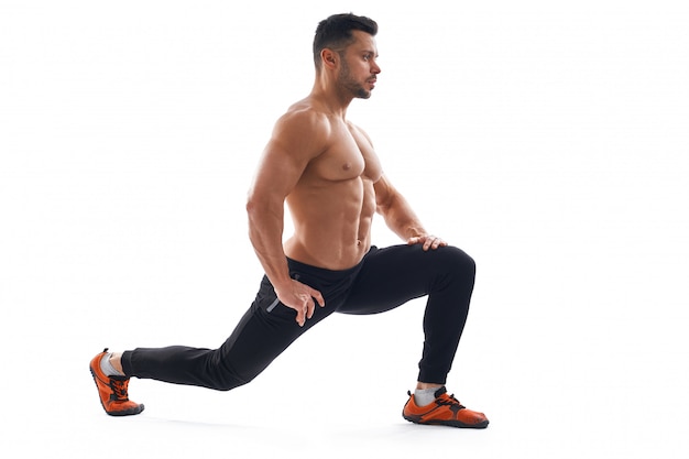 Free Photo | Shirtless bodybuilder stretching, isolated on white.