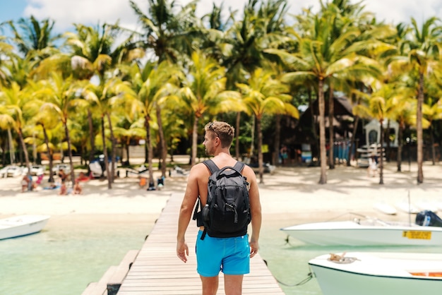 Premium Photo Shirtless Caucasian Man In Swimsuit And With Backpack