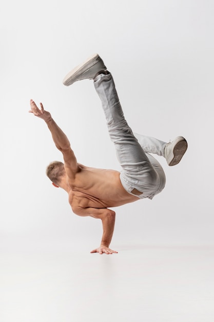 Premium Photo | Shirtless male dancer in jeans and sneakers posing ...