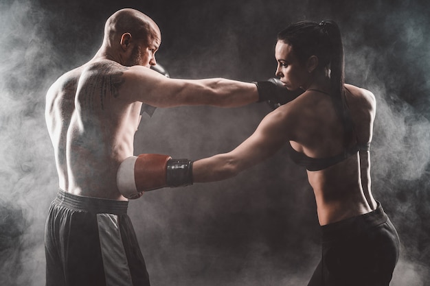 Premium Photo Shirtless Woman Exercising With Trainer At Boxing And