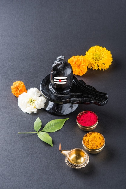 Premium Photo Shiva Linga Decorated With Flowers And Bel Patra Or Leaf