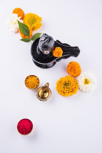 Premium Photo | Shiva linga decorated with flowers & bel patra or leaf ...