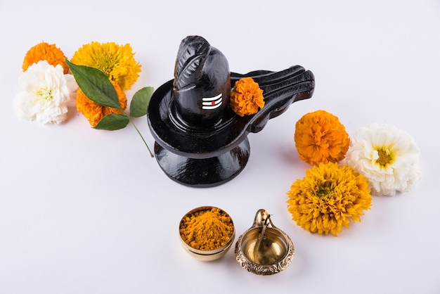 Premium Photo | Shiva linga decorated with flowers & bel patra or leaf ...