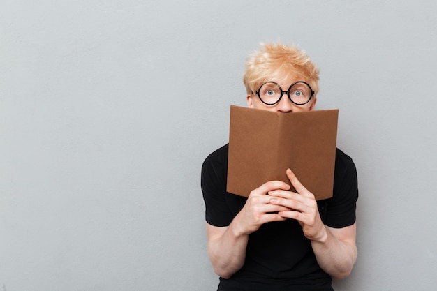 Shocked Caucasian Man Reading Book Free Photo