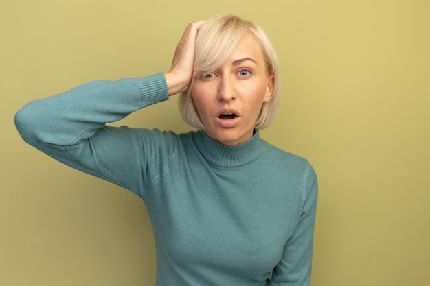 Free Photo Shocked Pretty Blonde Slavic Woman Putting Hand On Head On