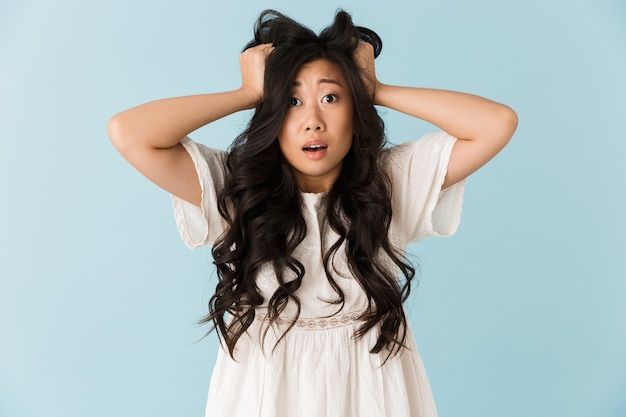 Premium Photo Shocked Scared Young Asian Beautiful Woman Posing Isolated Over Blue Wall