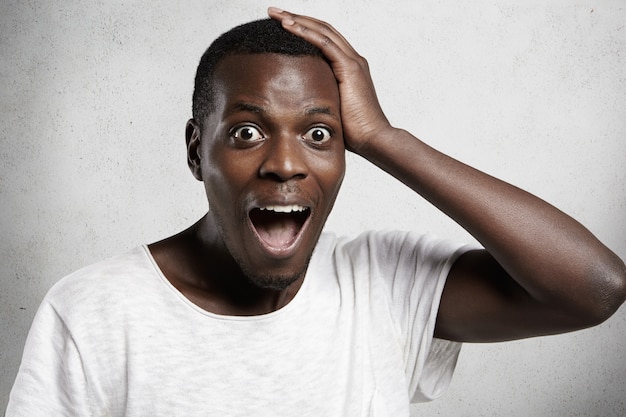 Free Photo | Shocked or surprised young handsome african man shouting