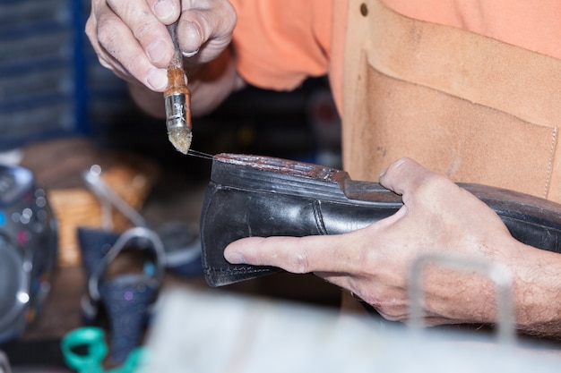 The shoemaker repairs a shoe Premium Photo