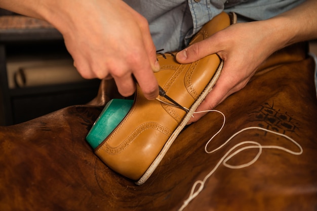 Free Photo Shoemaker In Workshop Making Shoes 7829