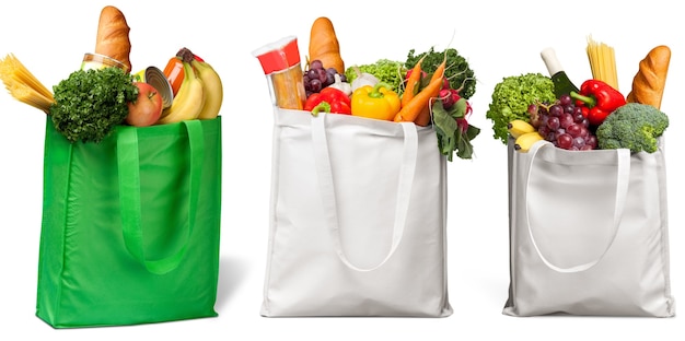 Premium Photo | Shopping bags with groceries isolated on white