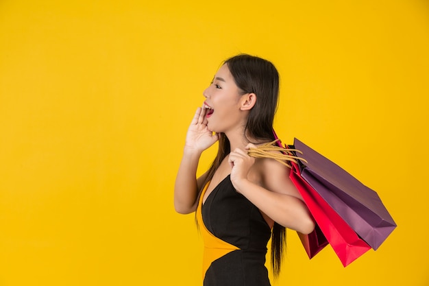 Free Photo Shopping Beautiful Woman Holding A Colorful Paper Bag On A