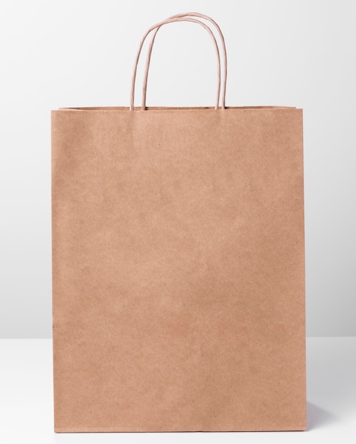 Free Photo | Shopping brown paper bag with thin handles front view