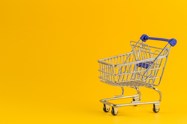 Download Premium Photo Shopping Cart On Bright Yellow Paper PSD Mockup Templates