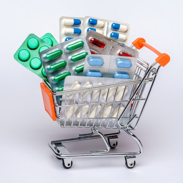 Premium Photo | Shopping cart with full of medical pills or vitamins ...