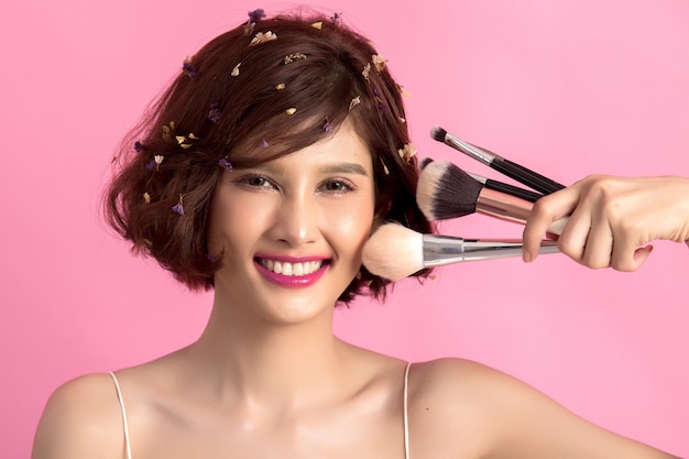 Short Hair Asian Young Beautiful Woman Applying Cosmetic Powder