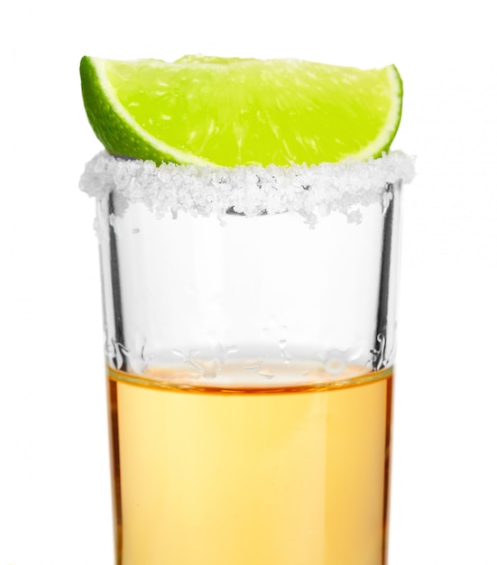 Premium Photo | Shot of tequila with a slice of lime on white