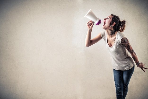 Premium Photo | Shouting into a megaphone