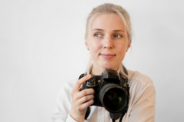 Shy Cute Girl Holding A Professional Camera Free