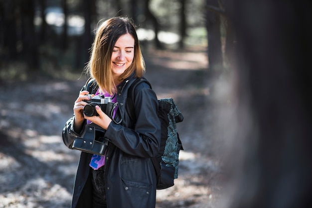 Shy Woman With Camera In Forest Free Photo