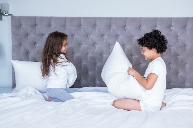 Premium Photo Siblings Pillow Fighting