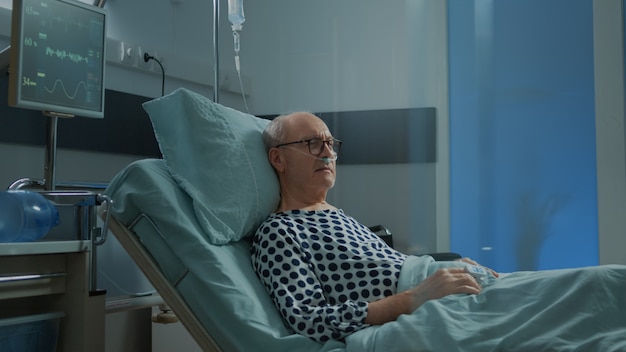 Premium Photo | Sick patient sitting in hospital ward with nasal oxygen ...