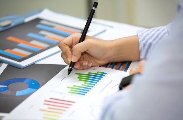 Premium Photo | Side angle view of business people writing on paperwork ...