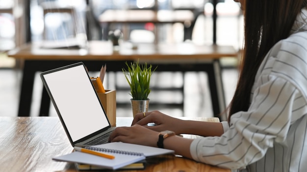 Premium Photo | Side shot of young creative woman typing on white blank ...