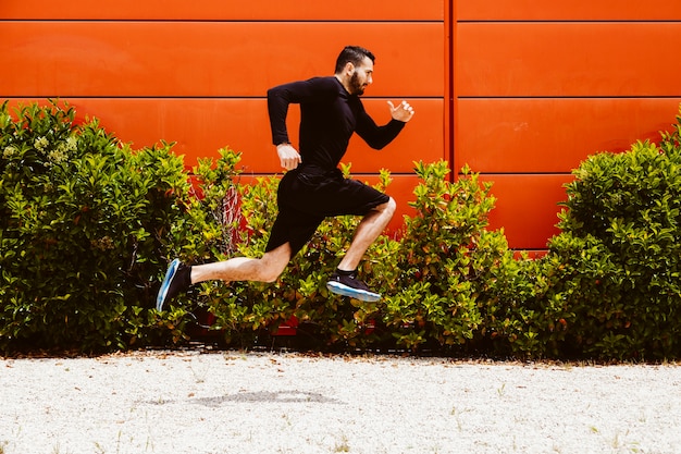 Free Photo | Side view of a athlete performing a long jump