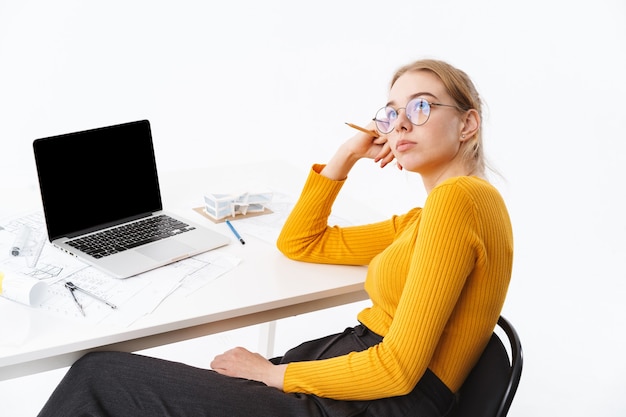 Premium Photo Side View Of A Beautiful Pensive Young Woman Sitting At The Workplace Working On 4178