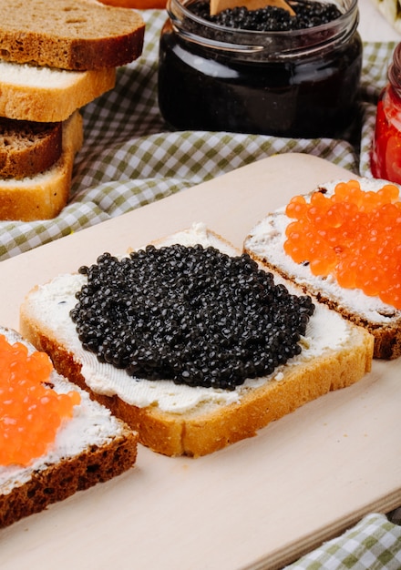 Free Photo | Side view black and red caviar toast rye and white bread ...