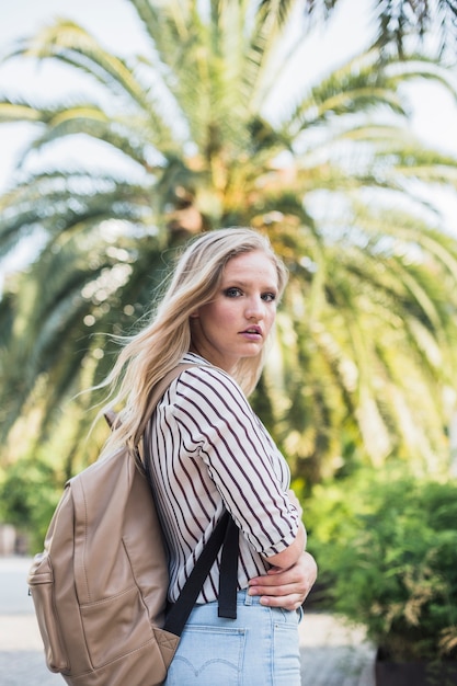 Free Photo | Side view of blonde young woman with her backpack