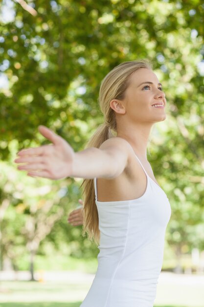 Premium Photo | Side view of cheerful attractive woman doing yoga ...