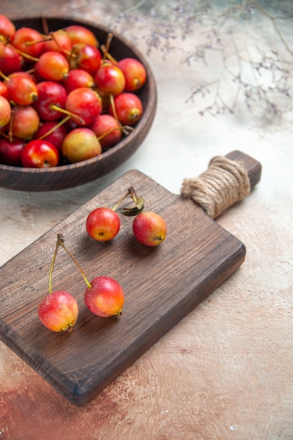 Free Photo Side View Cherries The Cutting Board With Berries Bowl Of Cherries Tree Branches