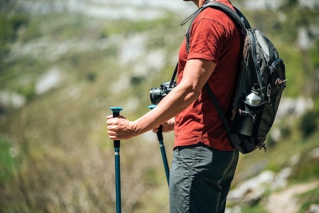 Premium Photo | Side view of crop faceless hiker with trekking poles ...