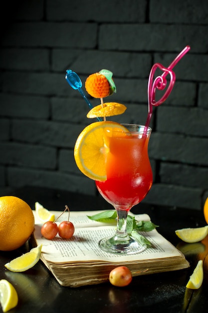 Free Photo | Side view of exotic cocktail with lemon slice and straw in ...