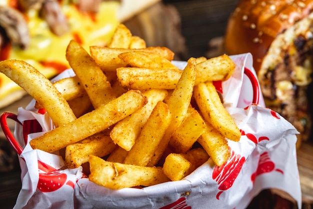 Side view french fries with seasoning Free Photo