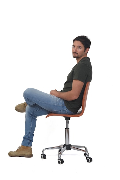 Premium Photo | Side view of a full portrait of man sitting on chair ...