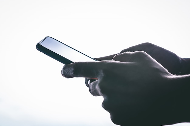 Premium Photo | Side view of hands is touching the screen against a ...