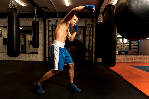 Free Photo | Side view of male boxer training