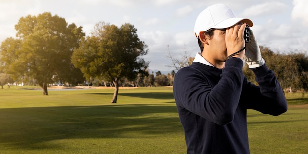 Free Photo | Side of with binoculars on the golf field