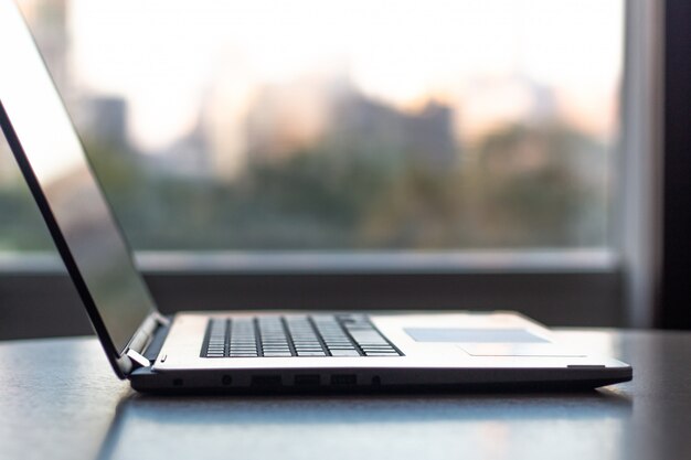 Premium Photo Side View Of Office Laptop Computer On Desk Table On With City Background