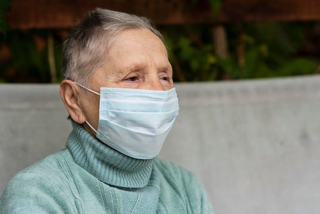 Free Photo Side View Of Older Woman With Medical Mask And Copy Space