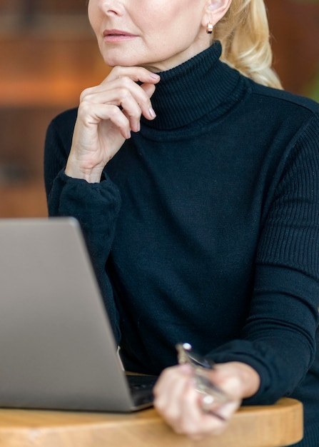 Free Photo Side View Of Pensive Older Woman With Glasses Working On Laptop 9267